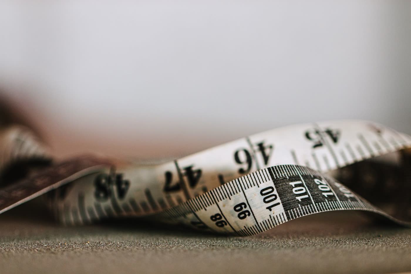 A close-up of a tape measure showing inch and centimeter markings